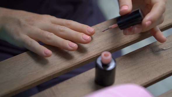 Closeup Shot of a Woman Doing Her Manicure Using Gel Polish That Hardens Under Ultraviolet Light