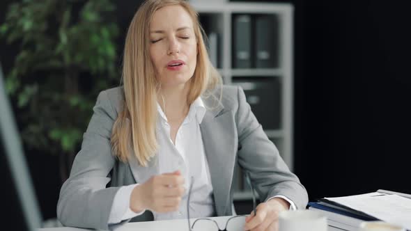 Sleepy Business Woman at Workplace