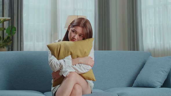 Unhappy Lonely Depressed Young Asian Woman At Home, She Is Sitting On The Couch, Depression Concept