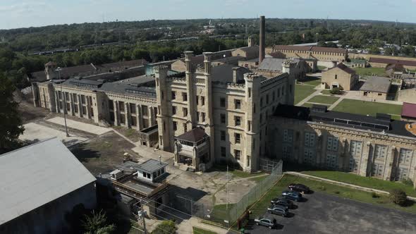 Aerial view of the derelict and abandoned Joliet prison or jail, a historic place. Drone slowly flyi