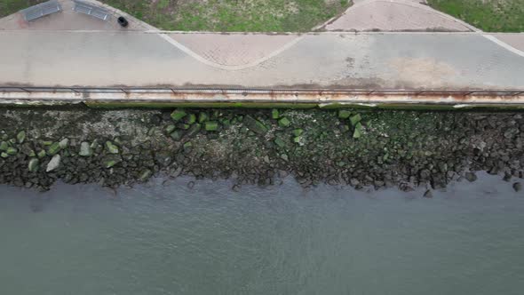A top down drone shot over a park on the edge of the east river. The camera tilted straight down tru