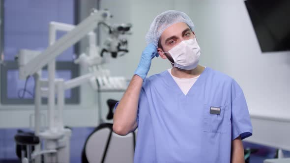 Dentist in Uniform Looking at Camera