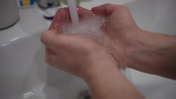 Man Put His Hands Under Running Water From Tap Water Saving Concept