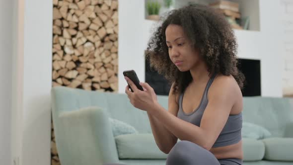 Fitness Young African Woman Browsing Smartphone