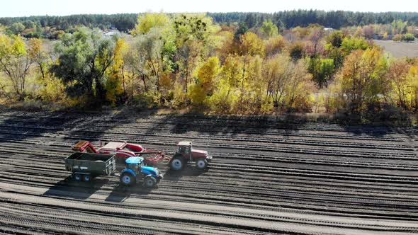 Useing Machinery at Farm Field During Potatoe Harvesting . Potatoe Picking Machine Digs and Picks