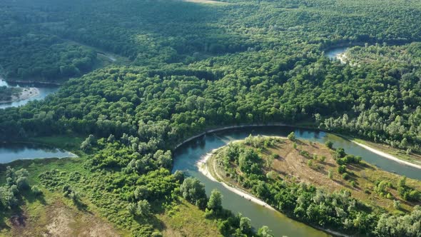 Aerial View of Winding River in Forest