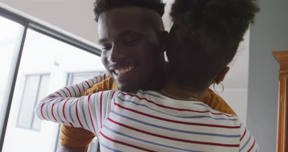 Video of happy african american couple embracing at home