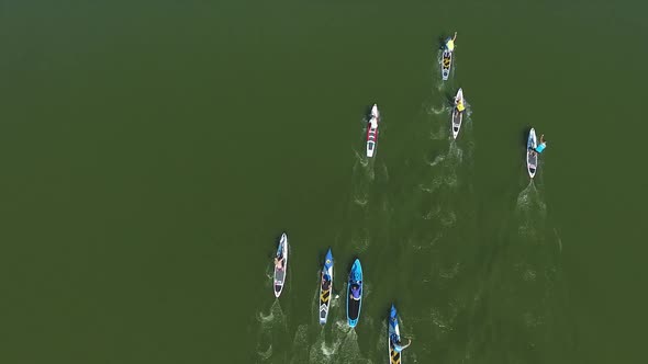 Aerial Top Down Shot of Stand Up Paddle Competition on Dark Green Water