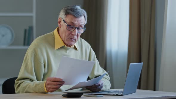 Worried Puzzled Old Caucasian Greyhaired Businessman 70s Male Sad Man Sitting at Table with