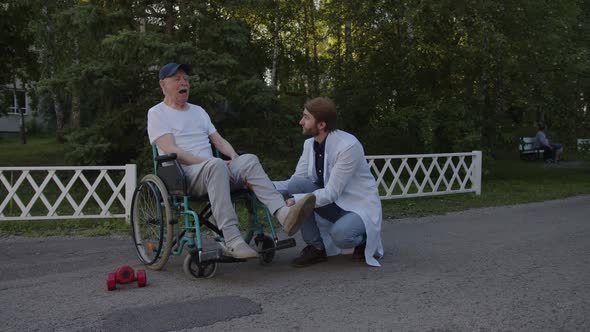 Doctor Shows How to Move Leg to His Patient