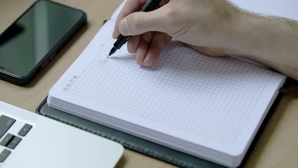 Caucasian Male Hand Writing in a Dairy