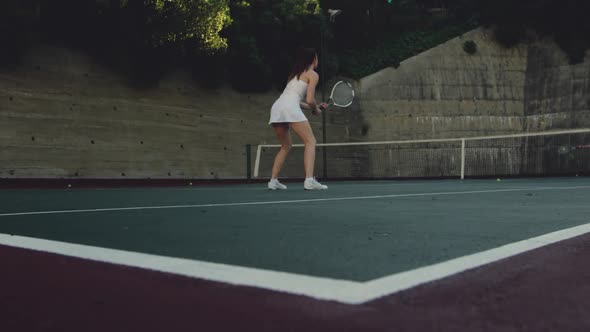 Woman and man playing tennis on a sunny day