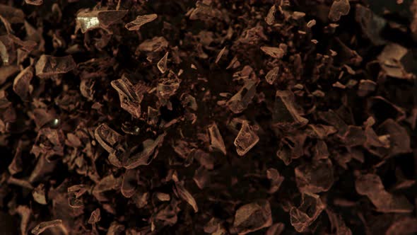 Super Slow Motion Shot of Raw Chocolate Chunks and Cocoa Powder After Being Exploded at 1000Fps.