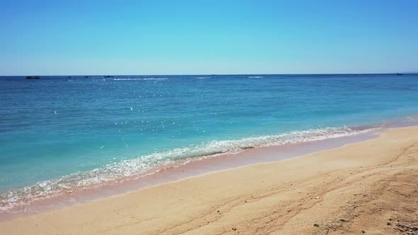 Aerial drone shot tourism of marine sea view beach adventure by blue ocean with white sand backgroun