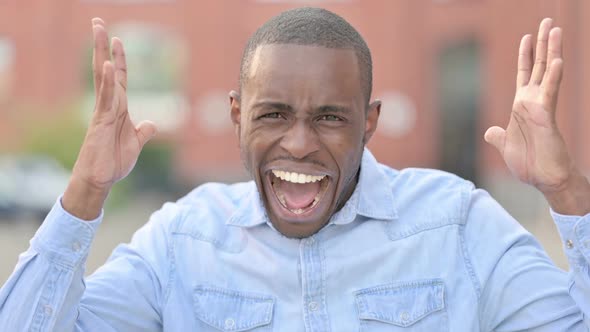 Outdoor Portrait of Angry African Man Shouting Screaming