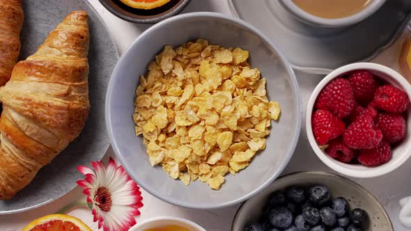 Delicious Breakfast with Corn Flakes Cereal Coffee Croissant Milk and Different Kinds of Berries