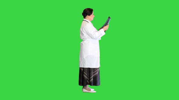 Mature Female Doctor Examining Patient's x Ray on a Green Screen Chroma Key