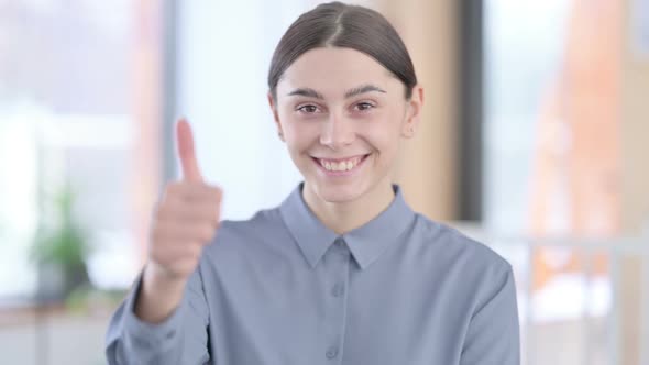 Portrait of Young Latin Woman Showing Thumbs Up Sign