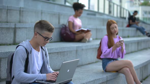 Genius University Student in Eyeglasses Working Laptop Outdoors, IT Job, Hobby