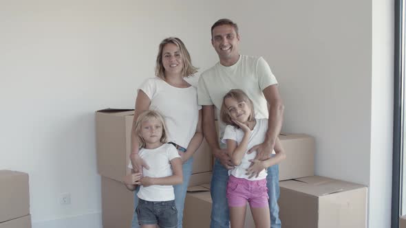 Happy Family Couple with Children Waving Hello