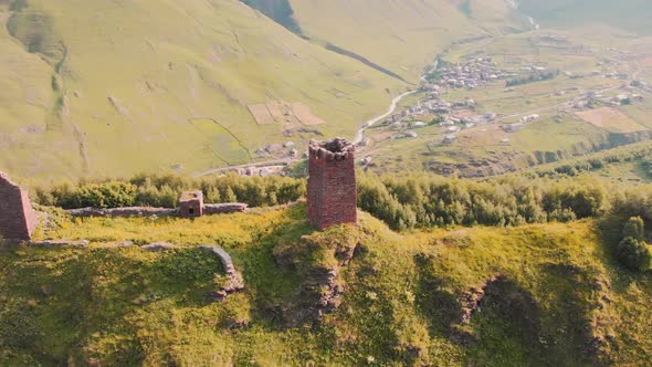 Aerial View Of Tower Ruins With Ushguli Village Background