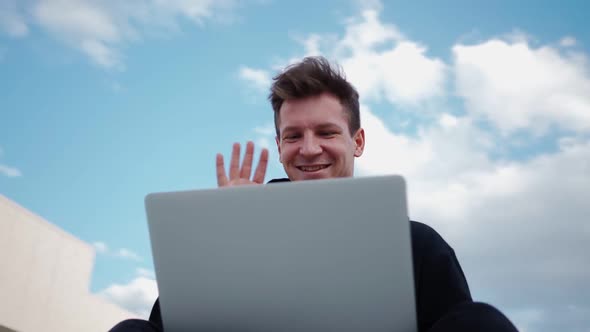 Guy Communicates on Video Call Using Laptop