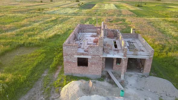 Aerial view od new brick unfinished house under construction.