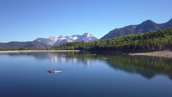 Flying over lake past people lying on paddle boards