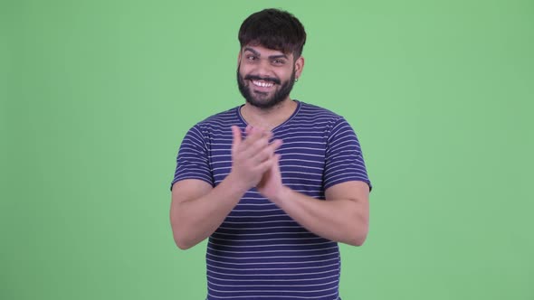 Happy Young Overweight Bearded Indian Man Clapping Hands