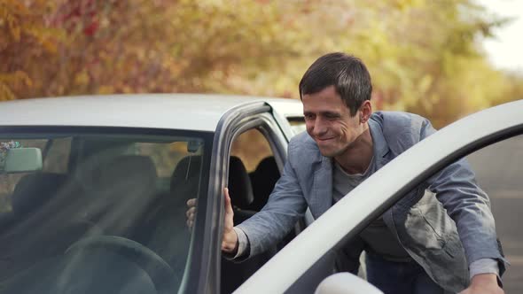 Man Pushing a Car with Empty Gas Tank