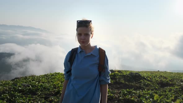 Girl Backpacker on Mountain Top