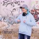 Blue haired teenager girl in hoodie wearing headphones and dancing against graffiti wall and laughin - VideoHive Item for Sale