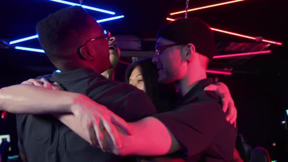 Multiracial Team of Esports Players Tune in to the Game and Embrace for Team Spirit Boost Slow