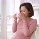 Asian mix race woman enjoying cup of coffee or tea drinking warm beverage at home - VideoHive Item for Sale
