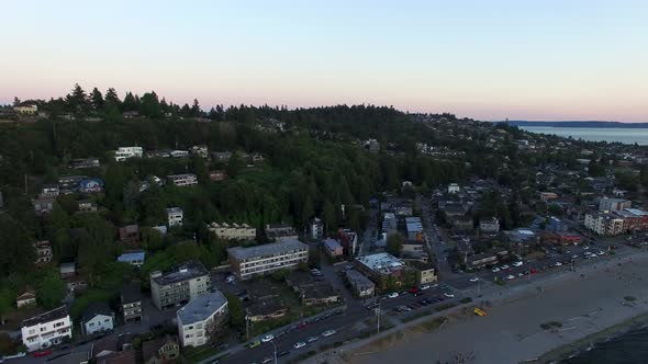 Aerial view pulling out towards the water of the Alki Beach community.