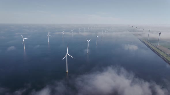 Offshore Windmill Park with Clouds and a Blue Sky Windmill Park in the Ocean Drone Aerial View with