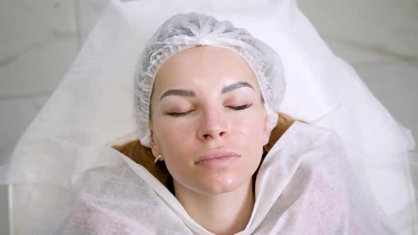 Face Beautiful Girl in a Medical Cap Lying Back on the Couch