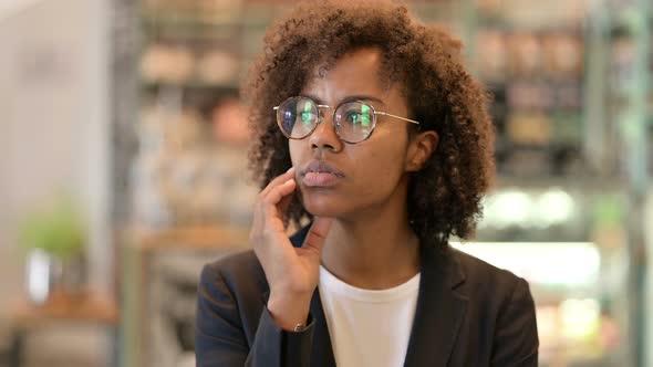 Pensive African Businesswoman Thinking of Ideas