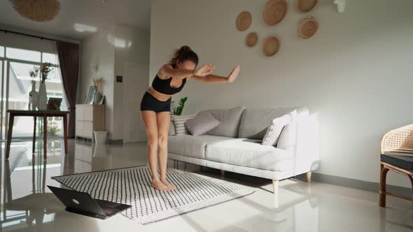 Pretty Young Woman Doing Yoga Online at Home. Healthy Lifestyle Concept