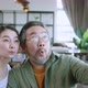 Asian family dad holding smartphone taking a selfie photo together happiness joyful - VideoHive Item for Sale