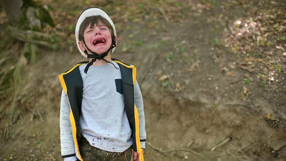 Cute Boy Crying in Forest After Falling