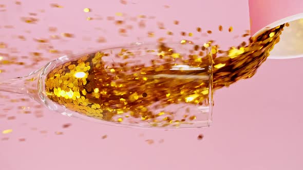 Colorful Candy Confectionery Run Poured Into a Wineglass Glass on Pink Background