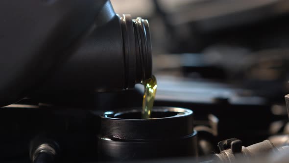 Pouring Oil Into Car's Engine