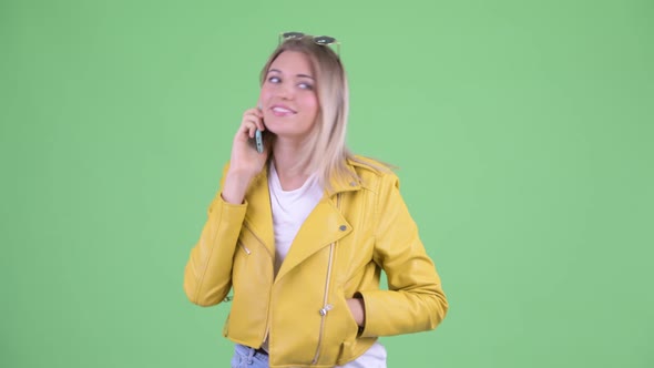 Happy Young Rebellious Blonde Woman Talking on the Phone