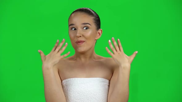 Very Surprised Girl in White Towel with Shocked Wow Face Expression on Green Screen at Studio
