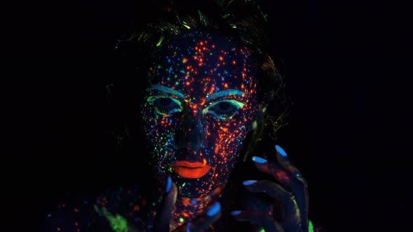 Fashion Model Woman in Neon Light, Fluorescent Make-up. Portrait of a Girl in the Neon Light. Face