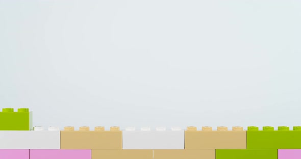 Colorful Bricks Making Wall on White Background alt