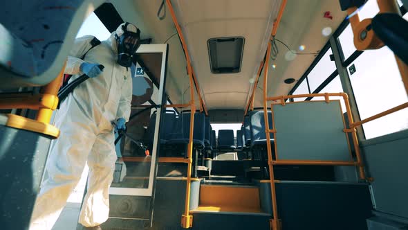 Coronavirus Prevention, Epidemic Concept. Inside View of a Bus Getting Sprayed with Disinfection