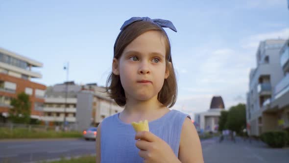 Cute Girl Walk Around the City and Eat Ice Cream