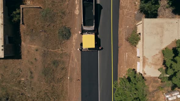 New road paving pressed by a road roller, Top down aerial view.